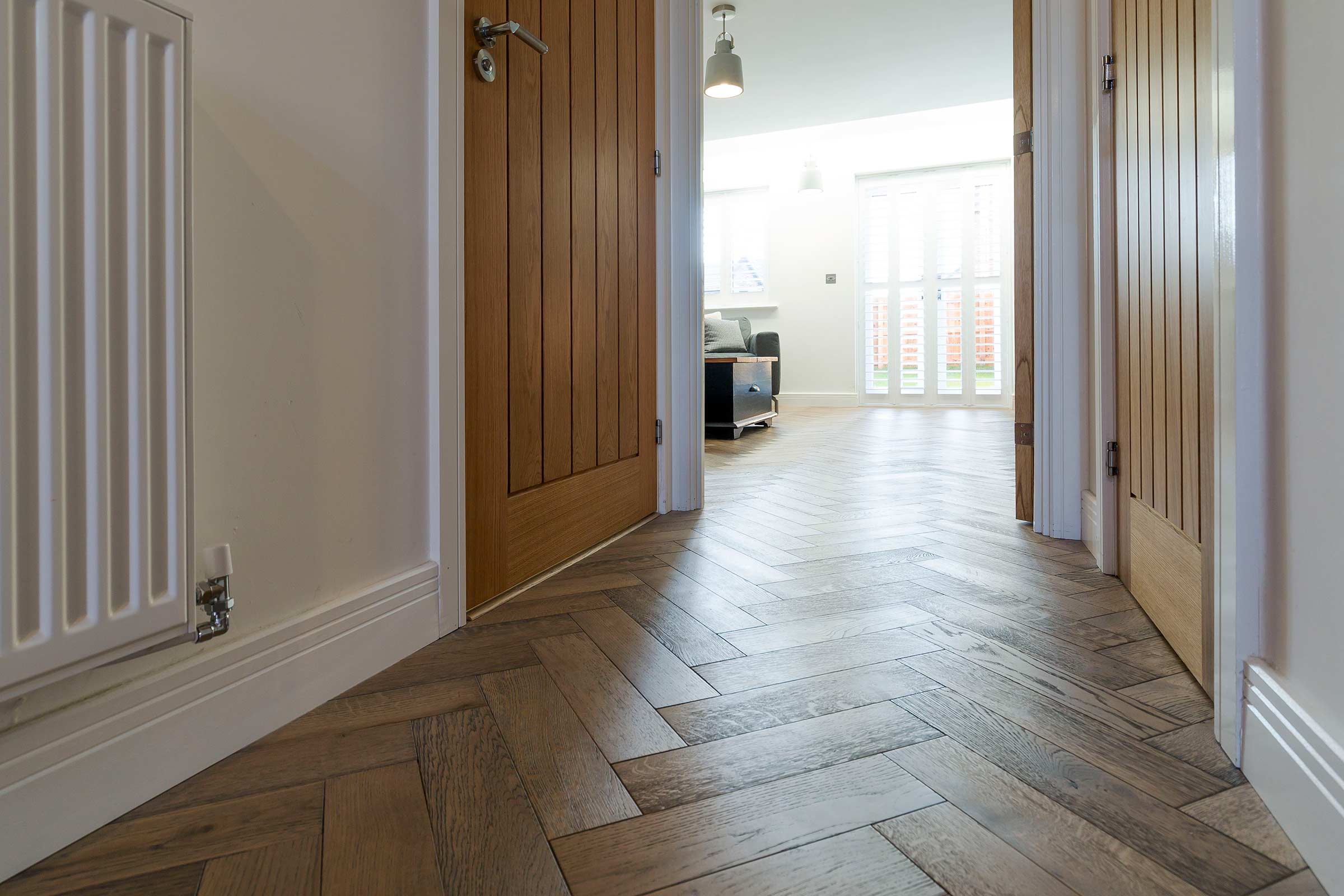 herringbone wood floor in a hallway