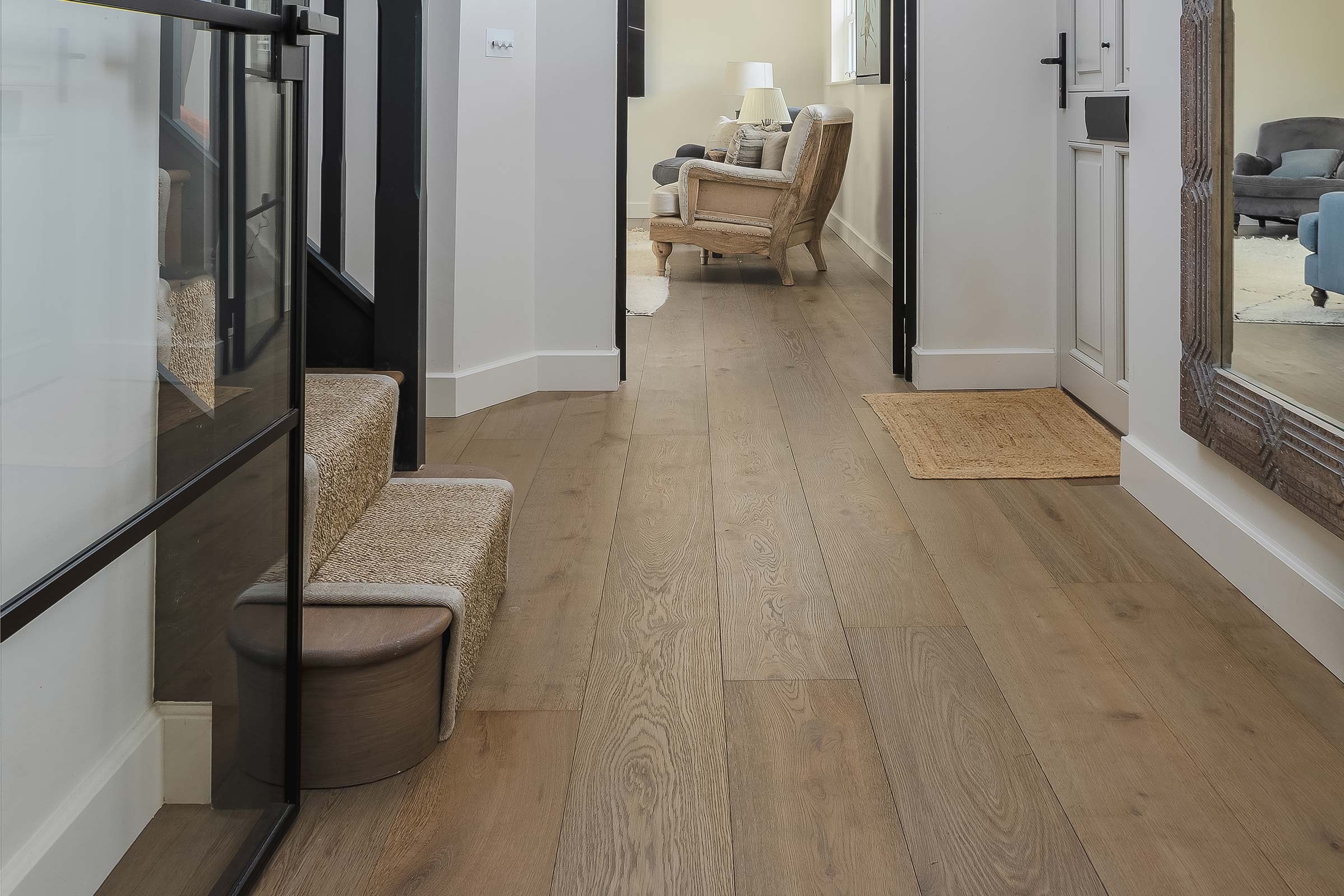 oak wood floors in a hallway with a staircase