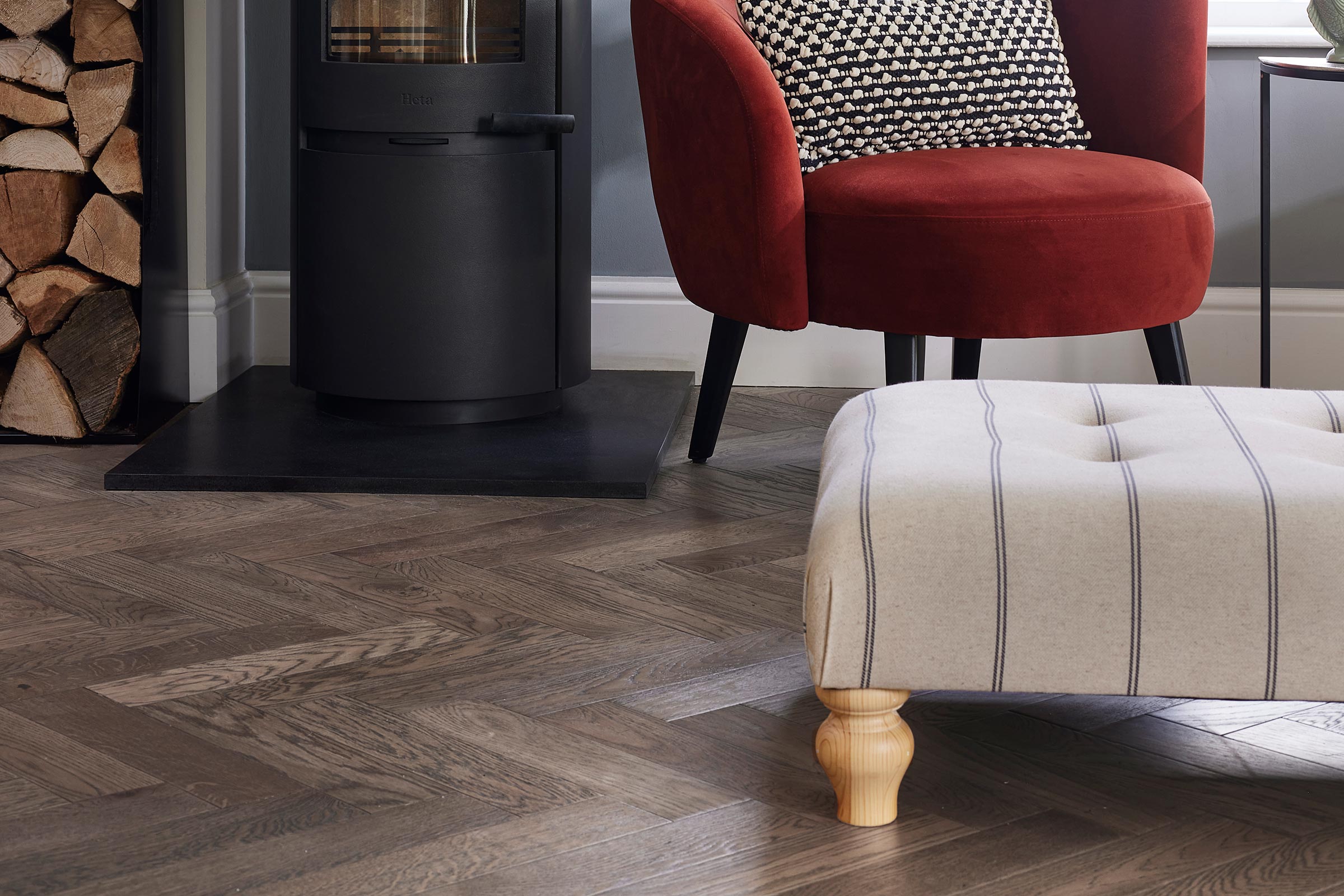 close up of dark herringbone wood floors in a modern living room